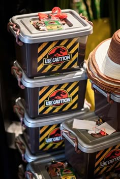 the hats are stacked on top of each other in plastic containers with yellow and black stripes