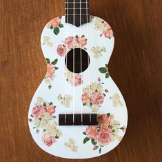 a ukulele with flowers painted on it