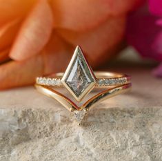 a diamond ring sitting on top of a rock