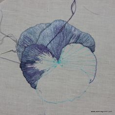 a drawing of a blue flower on a white background