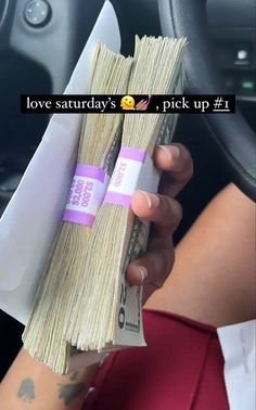 a person holding two bundles of money in their hand with the words love saturday's, pick up 1