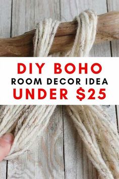 a hand holding a sign that says diy boho room decor idea under $ 25