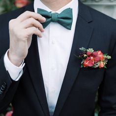 a man in a tuxedo with a boutonniere on his lapel