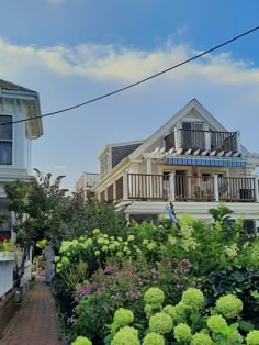 an image of a house with flowers in the foreground