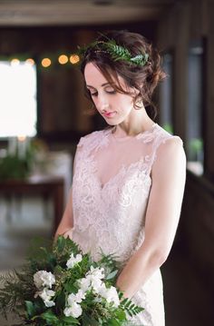 a woman in a wedding dress holding a bouquet