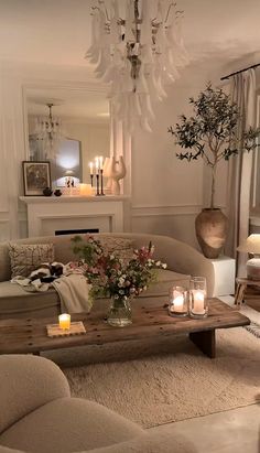 a living room filled with furniture and candles