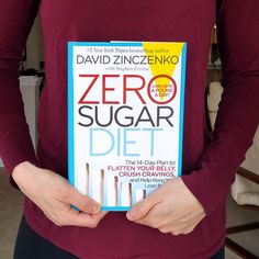 a person holding up a book about zero sugar diet in their hands, with the title'zero sugar diet'written on it