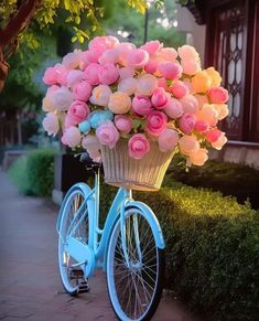 a blue bicycle with pink and white flowers in the basket on it's front wheel