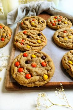 chocolate chip cookies with candy corn and m & m's on a cutting board