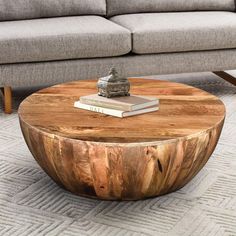 a coffee table made out of wood sitting on top of a carpeted living room floor