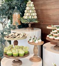 an assortment of cupcakes and cakes on display