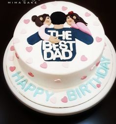 a white cake with pink and blue frosting on it that says the best dad