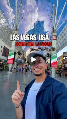 a man is giving the thumbs up sign in front of an indoor shopping mall with las vegas usa down town las vegas