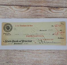 an old chequed check from the state bank of brecon on a wooden table