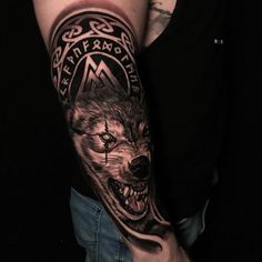 a man with a wolf tattoo on his arm