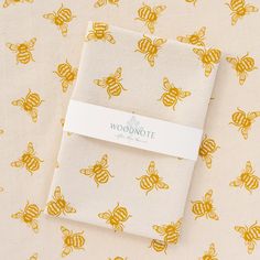 two bees on a yellow and white background with the word woonote written across it