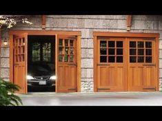 two cars are parked in front of the garage doors