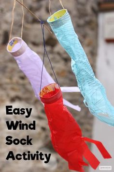 two paper fish hanging from strings with the words easy wind sock activity