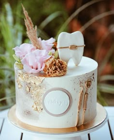 a white cake decorated with flowers and toothbrushes