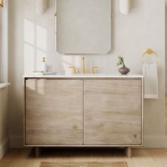 a bathroom with a wooden cabinet, mirror and two lights on the wall above it