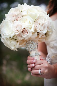 a bridal holding a bouquet of white flowers