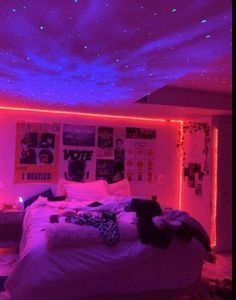 a bedroom with purple lights and pictures on the wall