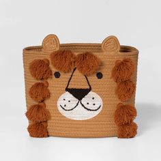 a brown basket with a lion face on it