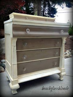 an old dresser is painted white and has knobs on the bottom drawer, which matches the rest of the chest