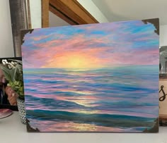 an oil painting of the ocean at sunset