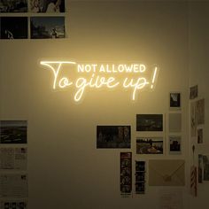 a neon sign that says not allowed to give up on the side of a wall