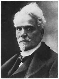 an old black and white photo of a man in a suit with a moustache