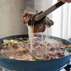 a person is stirring food in a pan on the stove