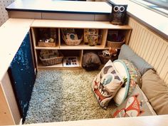 a room that has some shelves and stuffed animals on the floor in it, along with other items