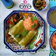 mexican food is served on colorful plates with sauces