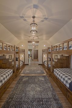 there are many bunk beds in this room with checkered blankets on the rugs