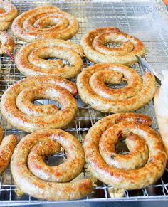 several sausage rings cooling on a rack in an oven with other food items around them