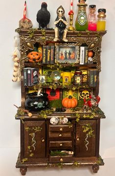 an old wooden cabinet with halloween decorations on top