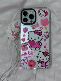 an iphone case with hello kitty stickers and earphones attached to the back cover