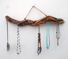 a piece of driftwood with beads hanging from it