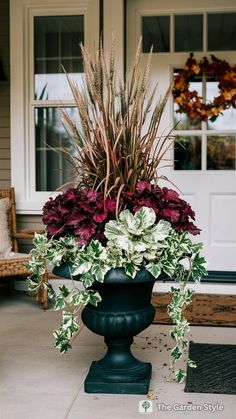 a large potted plant sitting on top of a cement slab in front of a house