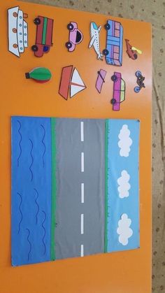 an orange bulletin board with cars, trucks and planes on the road painted on it