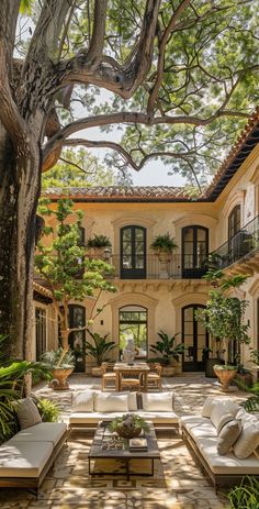 an outdoor living area with couches and tables