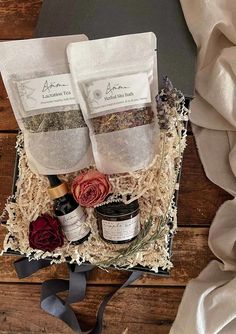 three bags of herbs sitting on top of a wooden table