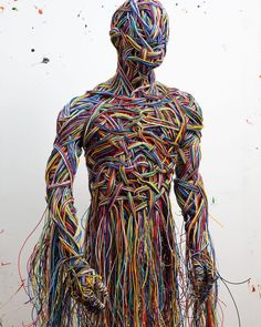 an image of a man made out of many colored wires and wires on the back of his body