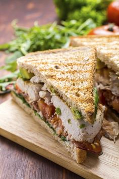 a cut in half sandwich sitting on top of a cutting board