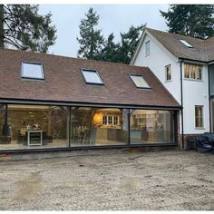 an image of a house that is being built in the middle of the day with large windows