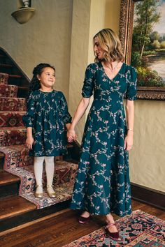 The Charlotte Dress in Midnight Garden with its romantic winding blossom print set against a stargazer blue background is both elegant and playful. With a full, airy skirt and delicate pintucks at the front and back of the bodice, it’s perfect for twirling through fall festivities. The elasticized wrists and mother-of-pearl back snaps make this a throw-on-and-go style you will be reaching for all season. Pair it with the Elaine Dress in Midnight Garden for a coordinating mother and child look. A Elaine Dress, Charlotte Dress, Fall Festivities, Midnight Garden, Bias Cut Skirt, Baby Bottoms, Blossom Print, Background Fabric, Boys Bottoms