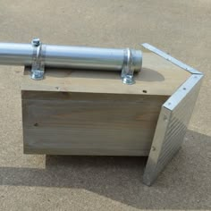 a metal object sitting on top of a wooden box in the middle of the ground