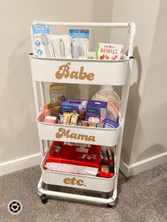 a baby changing cart with the word babe on it's side and various items inside