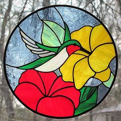 a stained glass window with flowers in the center and leaves on it's side